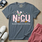 Neonatal Intensive Care Unit NICU nursing t-shirt featuring the letters NICU in a pink plaid pattern with bunny ears on the I, alongside a basket and Easter eggs, positioned above the cursive text "Neonatal Intensive Care Unit Nurse".
