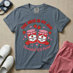 A t-shirt featuring two jars of strawberry jam surrounded by small hearts and strawberries with the text THE NICU IS MY JAM arched above and Neonatal ICU Nurse written in a retro script below.