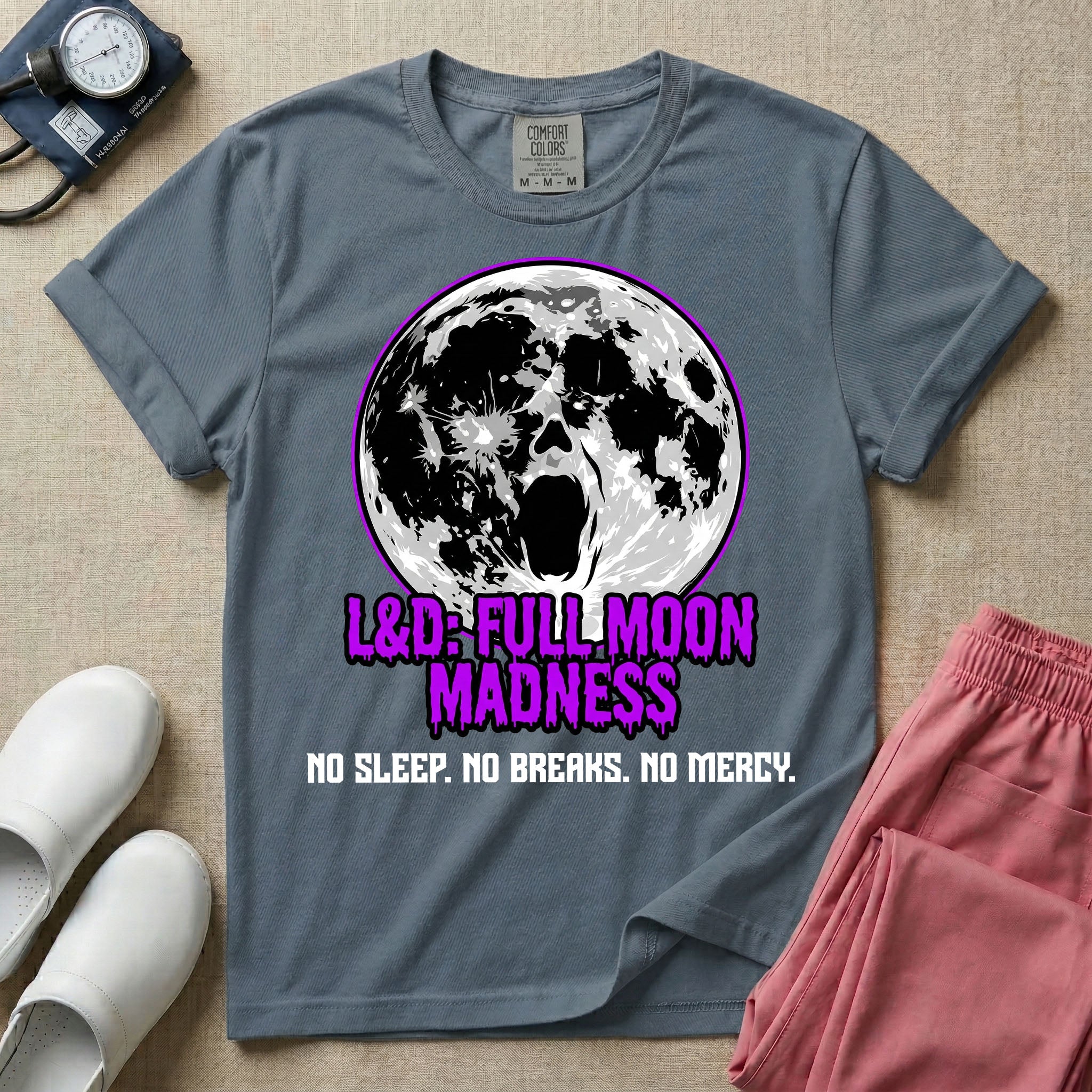 A humorous Labor and Delivery nurse graphic featuring a screaming face morphing out of a full moon, accompanied by purple dripping text that reads L&D: FULL MOON MADNESS and distressed black text below reading NO SLEEP. NO BREAKS. NO MERCY.
