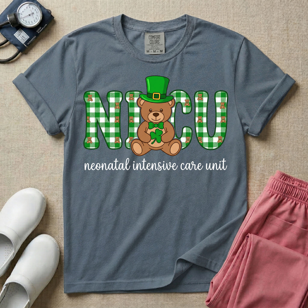 A graphic for a Neonatal Intensive Care Unit featuring the word 'NICU' in green and white plaid patterned letters, with a cute brown teddy bear wearing a leprechaun hat and holding a shamrock sitting in the middle, and the cursive text 'neonatal intensive care unit' underneath.