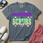 General nursing St. Patrick's Day t-shirt featuring a retro wavy font with the text "SHENANIGANS & SCRUBS" surrounded by shamrock graphics and a stethoscope.