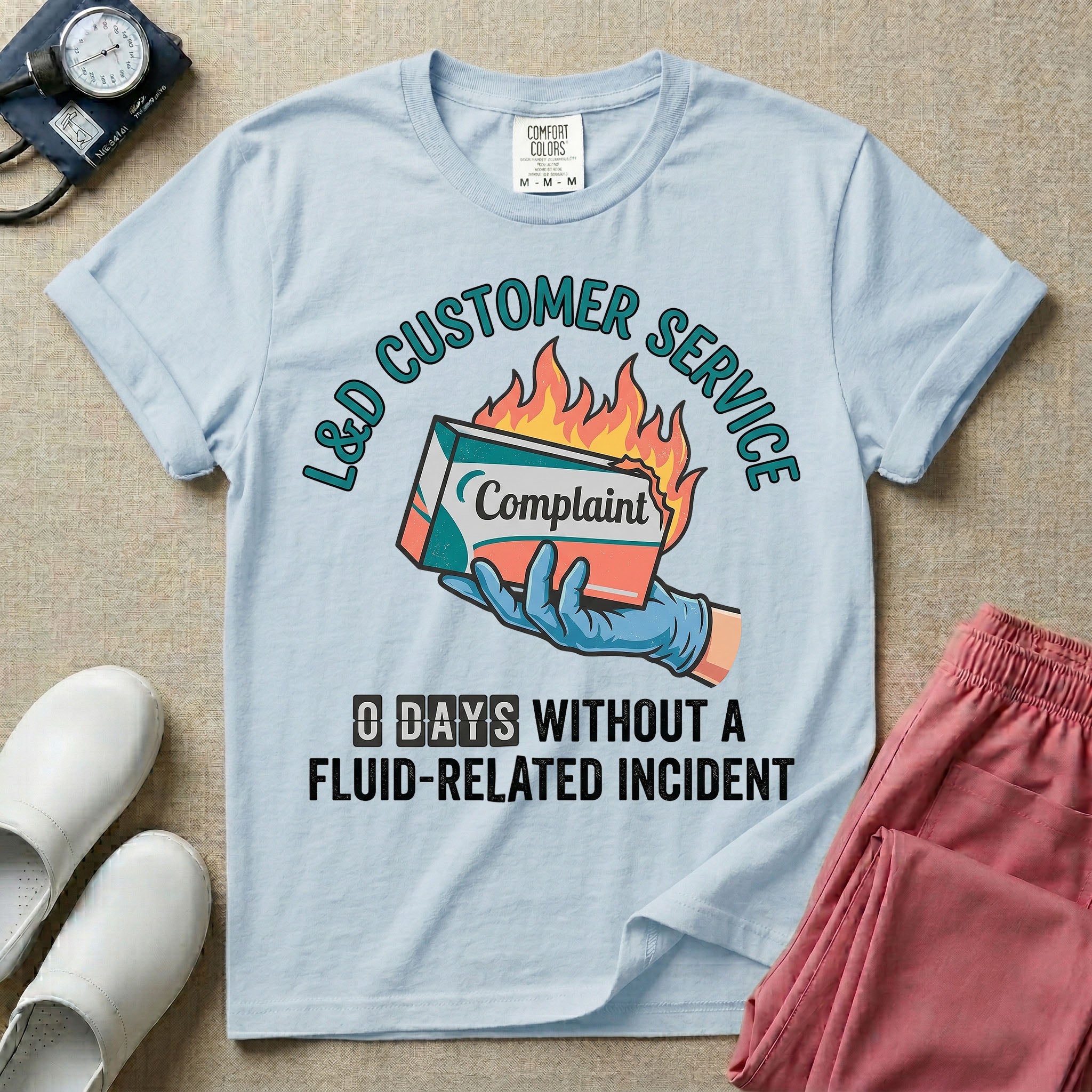 Labor and Delivery L&D nurse t-shirt with funny customer service burning complaint box and zero days without a fluid-related incident graphic in chambray color.