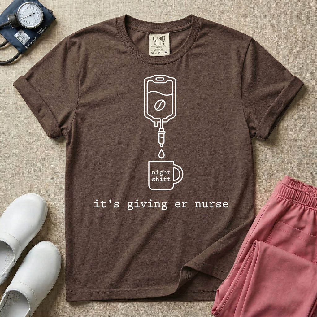 A funny minimalist ER nursing t-shirt featuring a white line drawing of an IV bag containing a coffee bean dripping into a mug labeled "night shift", sitting above the lower-case typewriter text "it's giving er nurse".