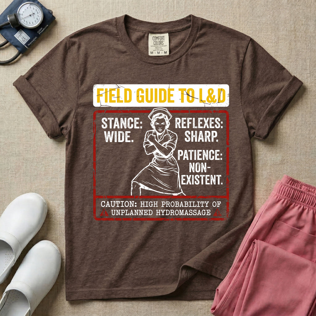 A humorous and retro graphic tee for labor and delivery nurses featuring a vintage nurse illustration alongside the text "FIELD GUIDE TO L&D", "STANCE: WIDE", "REFLEXES: SHARP", "PATIENCE: NON-EXISTENT", and "CAUTION: HIGH PROBABILITY OF UNPLANNED HYDROMASSAGE".
