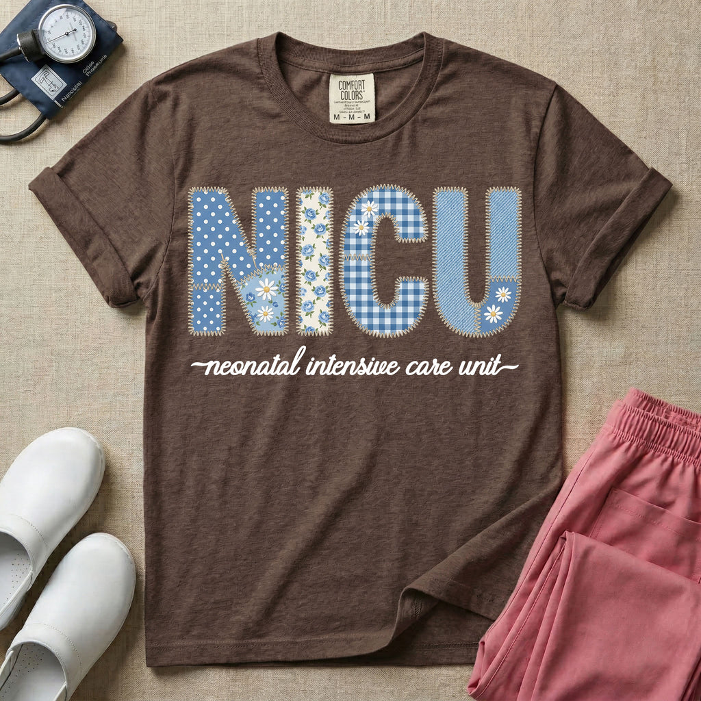 A t-shirt for NICU nurses featuring the large text "NICU" designed to look like faux embroidery with floral and plaid patterns, and the words "neonatal intensive care unit" written in a delicate script font underneath.