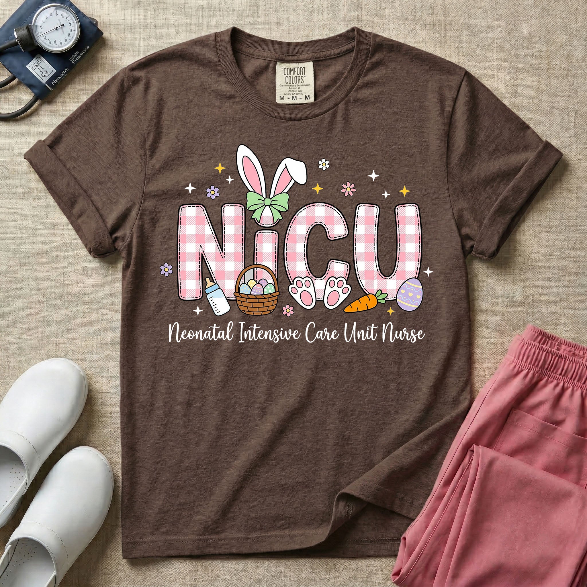 Neonatal Intensive Care Unit NICU nursing t-shirt featuring the letters NICU in a pink plaid pattern with bunny ears on the I, alongside a basket and Easter eggs, positioned above the cursive text "Neonatal Intensive Care Unit Nurse".