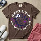 General nursing night shift nurse t-shirt with a retro purple moon wearing a nurse cap and we thrive in the chaos graphic in espresso color.