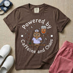 A humorous General Nursing graphic featuring an exhausted owl wearing scrubs and a nurse hat, hooked up to an IV bag labeled CAFFEINE NIGHT SHIFT FUEL, surrounded by coffee beans, stars, and moons, with circular text reading Powered by Caffeine and Chaos.