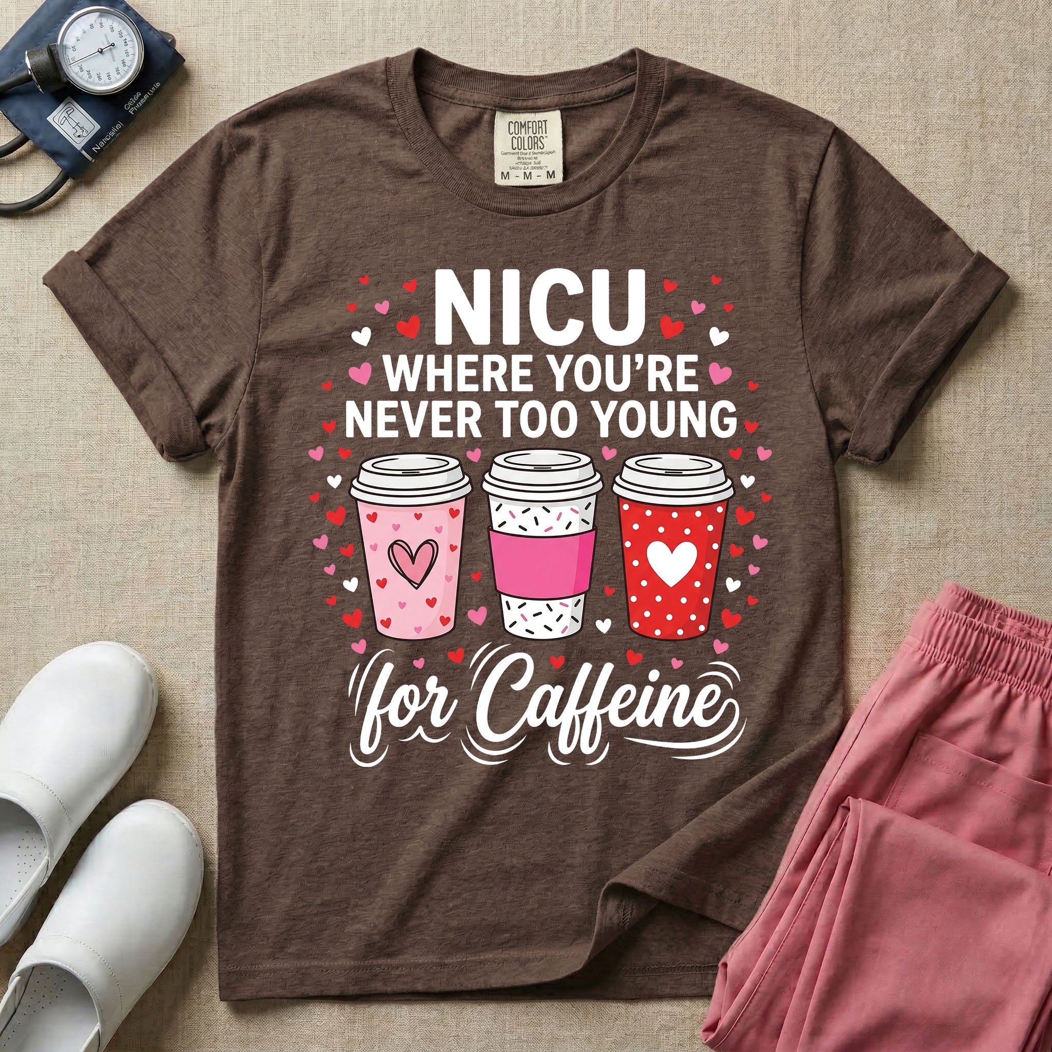 A Valentine's Day themed graphic for a Neonatal Intensive Care Unit featuring the text 'NICU WHERE YOU'RE NEVER TOO YOUNG' stacked above three to-go coffee cups decorated with heart patterns, with 'for Caffeine' written in script at the bottom, all surrounded by small red and pink hearts.