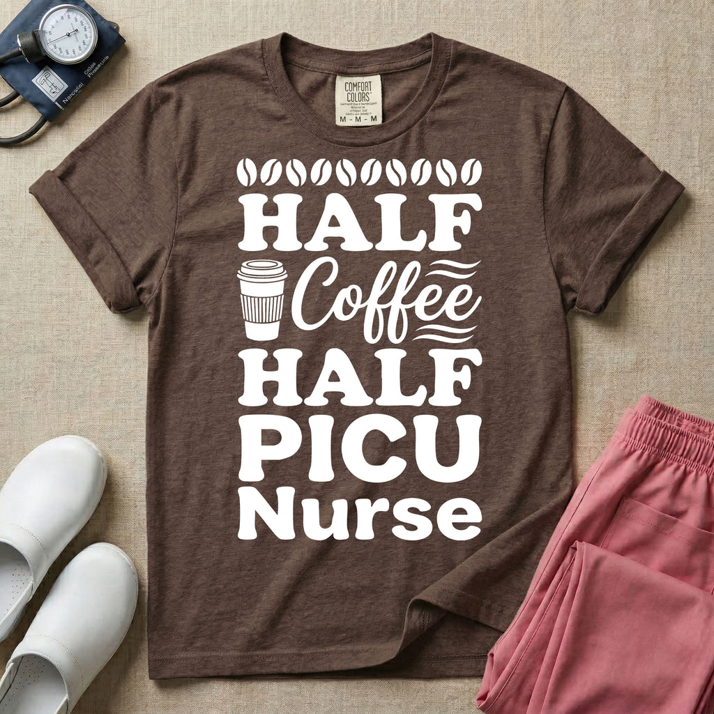 A funny pediatric intensive care nursing t-shirt featuring the stacked white text "HALF COFFEE HALF PICU Nurse" accented with simple graphics of coffee beans and a to-go coffee cup.