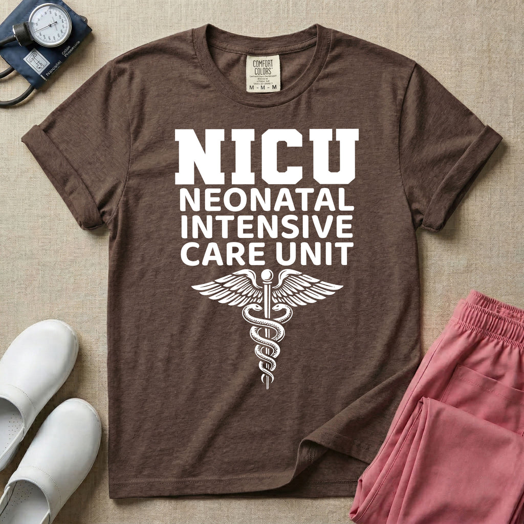 A t-shirt featuring the word NICU in large collegiate block letters above the spelled-out text Neonatal Intensive Care Unit and a medical caduceus symbol.
