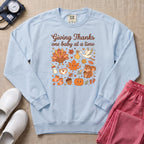Retro Giving Thanks One Baby At A Time Thanksgiving L&D and NICU Nurse Sweatshirt - Chambray Comfort Colors Sweatshirt | HugTee