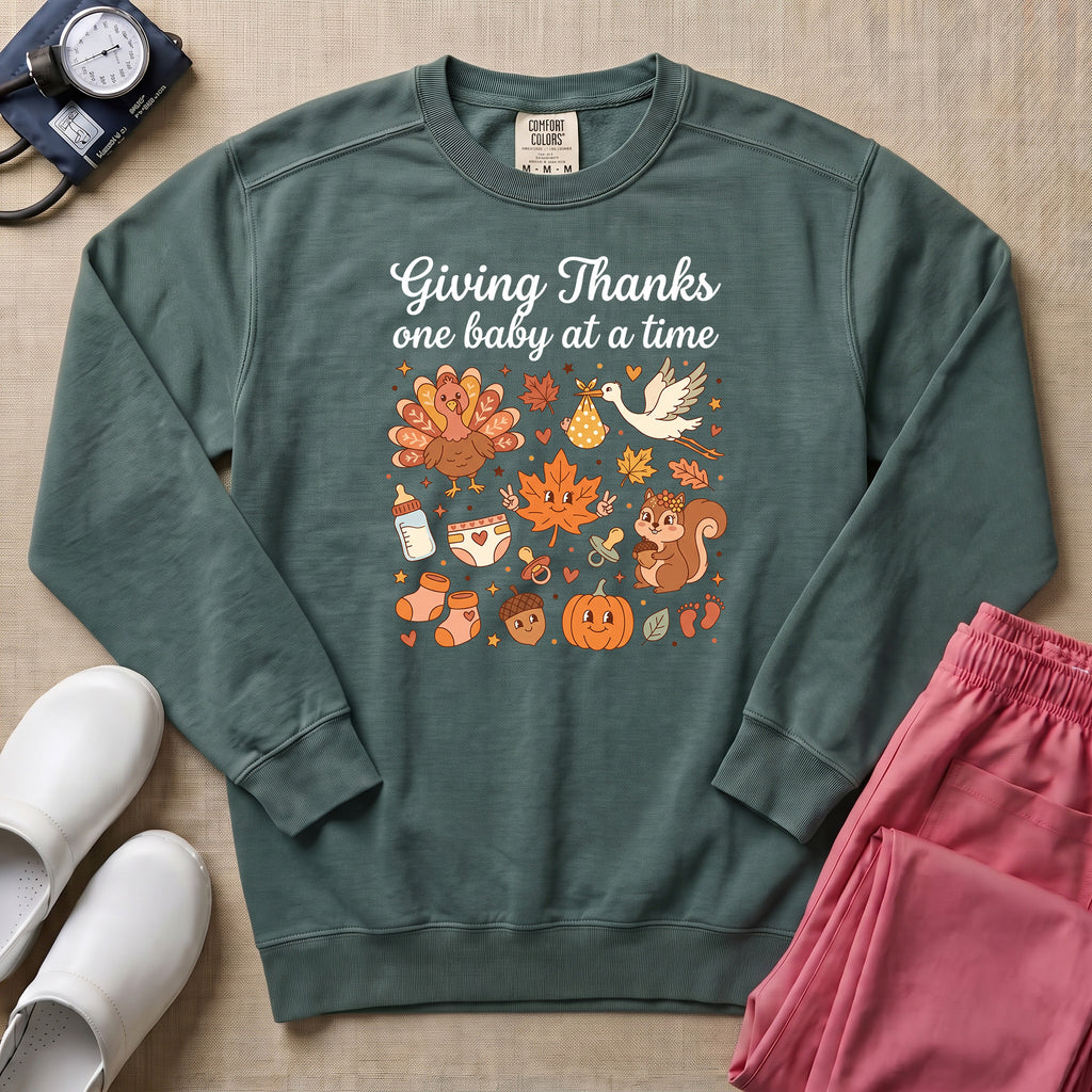 Retro Giving Thanks One Baby At A Time Thanksgiving L&D and NICU Nurse Sweatshirt - Blue Spruce Comfort Colors Sweatshirt | HugTee