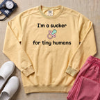 I'm A Sucker For Tiny Humans Funny Pediatric NICU Nurse Sweatshirt - Butter Comfort Colors Sweatshirt | HugTee