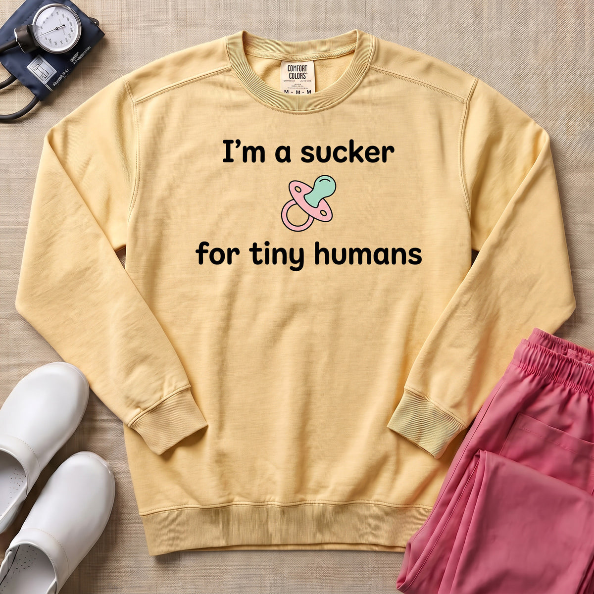 I'm A Sucker For Tiny Humans Funny Pediatric NICU Nurse Sweatshirt - Butter Comfort Colors Sweatshirt | HugTee