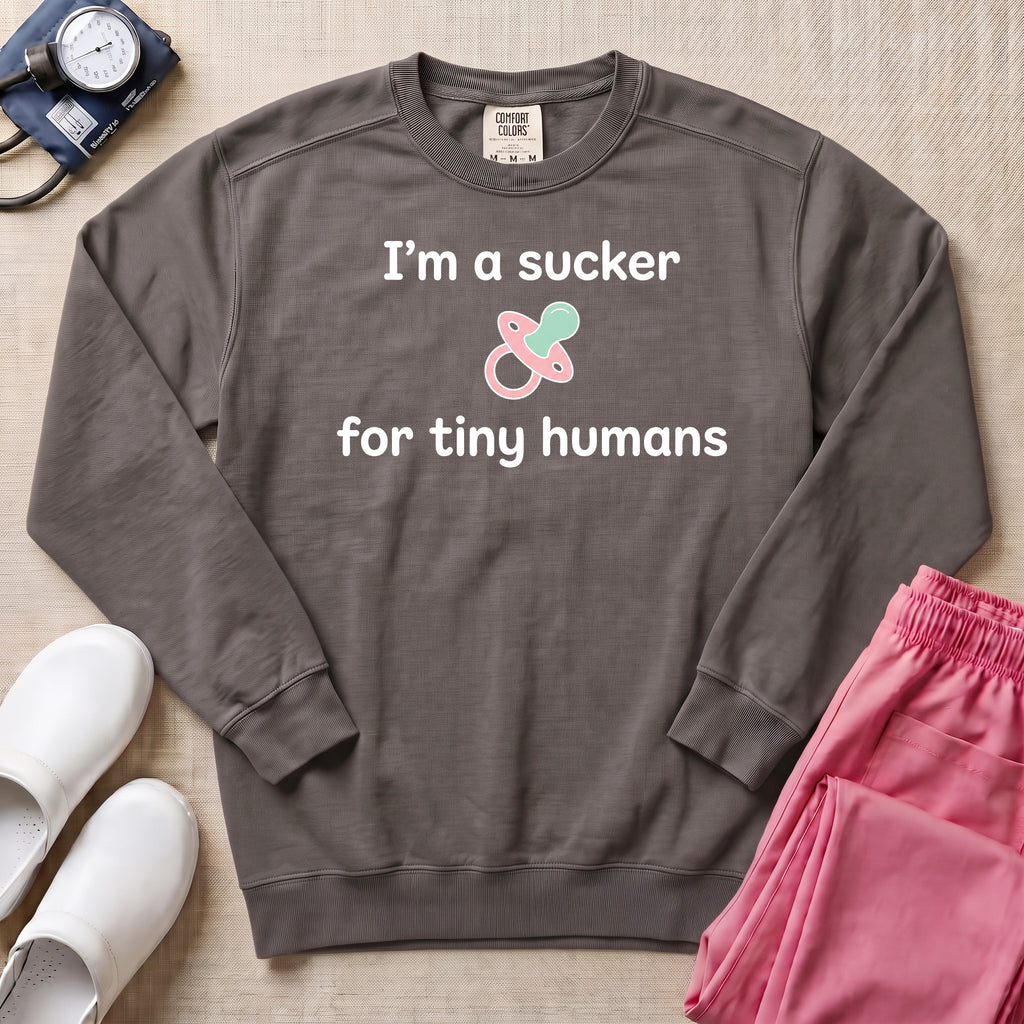 I'm A Sucker For Tiny Humans Funny Pediatric NICU Nurse Sweatshirt - Pepper Lifestyle Hero Mockup | HugTee