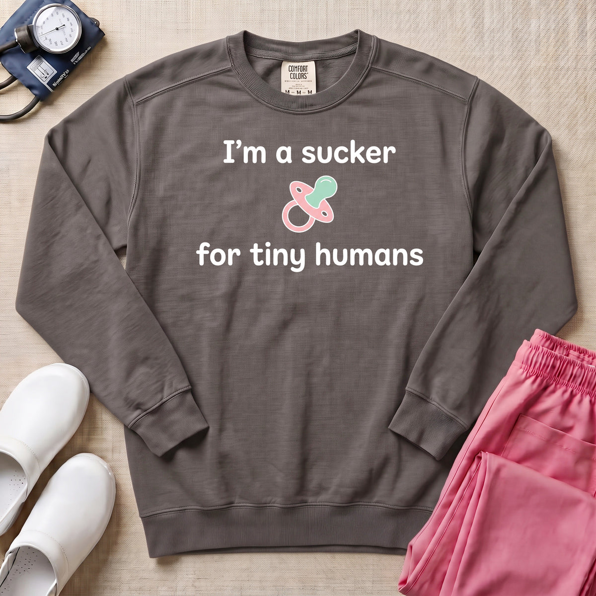 I'm A Sucker For Tiny Humans Funny Pediatric NICU Nurse Sweatshirt - Pepper Lifestyle Hero Mockup | HugTee