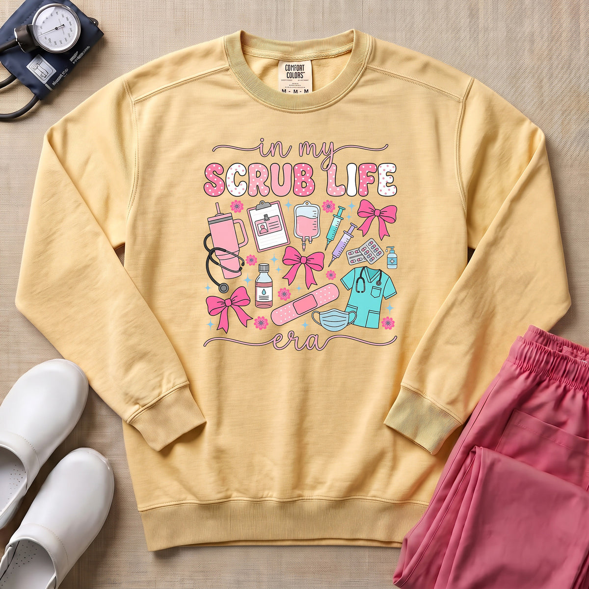 In My Scrub Life Era Coquette Nurse Sweatshirt - Butter Comfort Colors Sweatshirt | HugTee