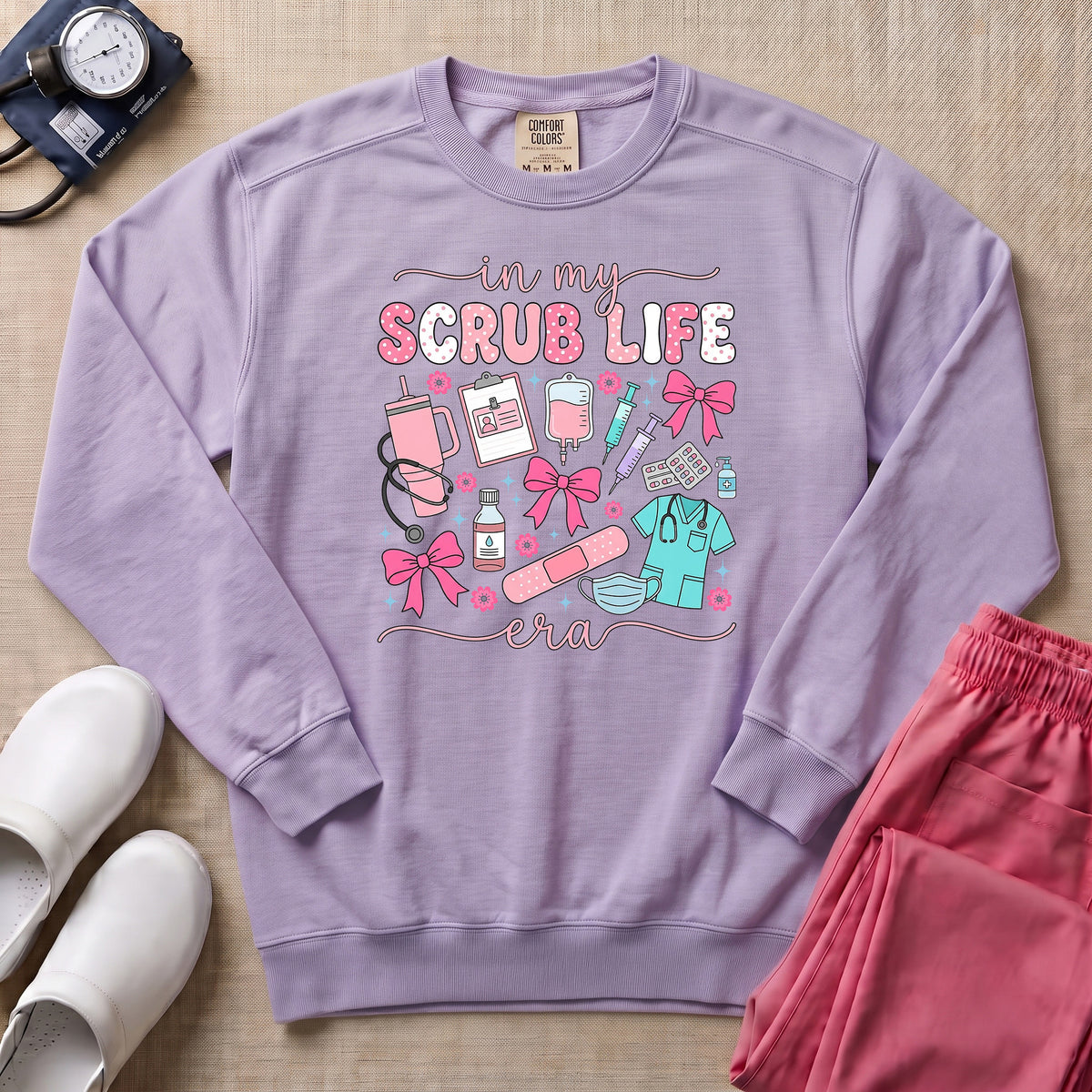 In My Scrub Life Era Coquette Nurse Sweatshirt - Orchid Comfort Colors Sweatshirt | HugTee