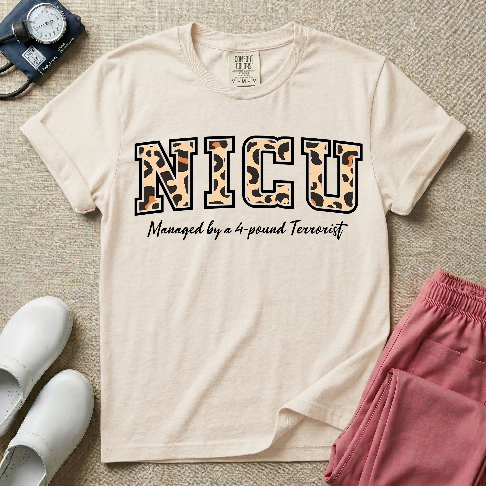 Neonatal Intensive Care Unit NICU nurse t-shirt with leopard print block letters and funny managed by a 4-pound terrorist graphic in ivory color.