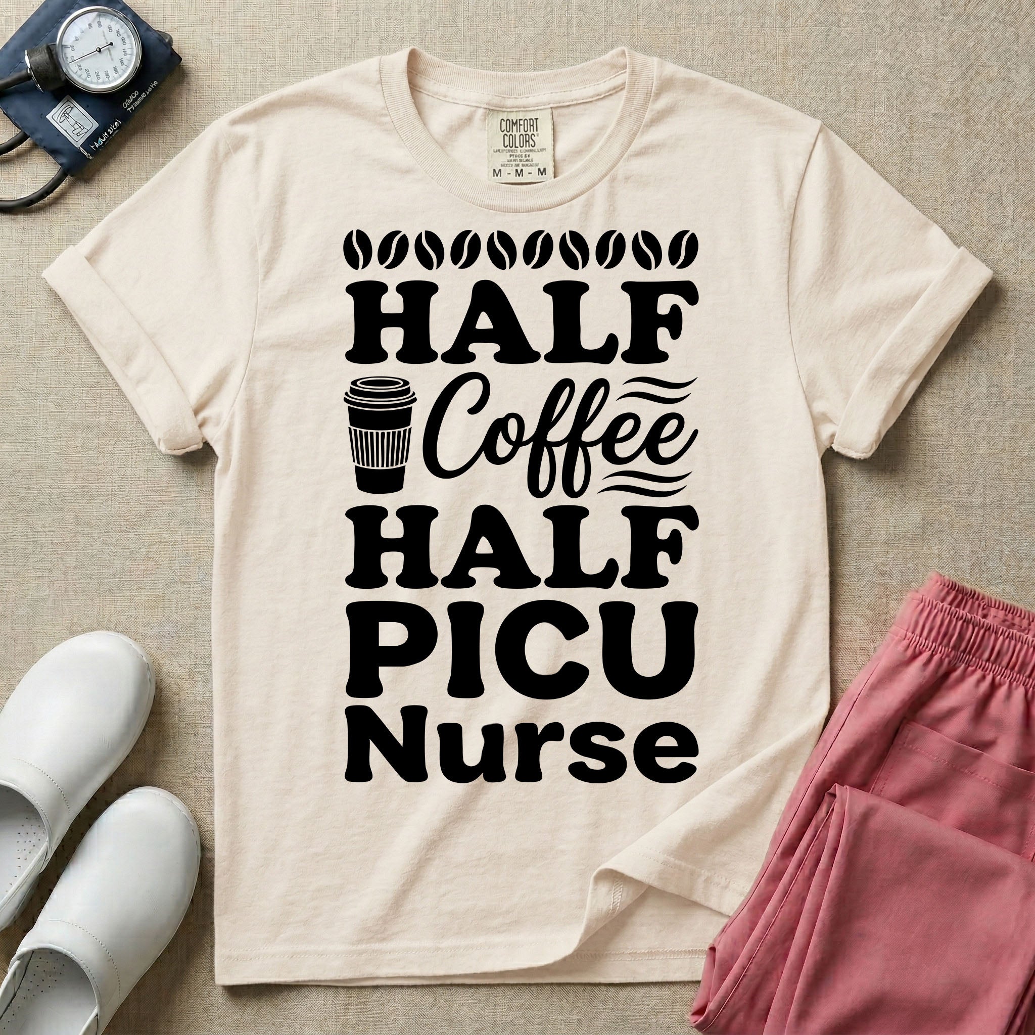 A funny pediatric intensive care nursing t-shirt featuring the stacked white text "HALF COFFEE HALF PICU Nurse" accented with simple graphics of coffee beans and a to-go coffee cup.