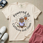 A humorous General Nursing graphic featuring an exhausted owl wearing scrubs and a nurse hat, hooked up to an IV bag labeled CAFFEINE NIGHT SHIFT FUEL, surrounded by coffee beans, stars, and moons, with circular text reading Powered by Caffeine and Chaos.