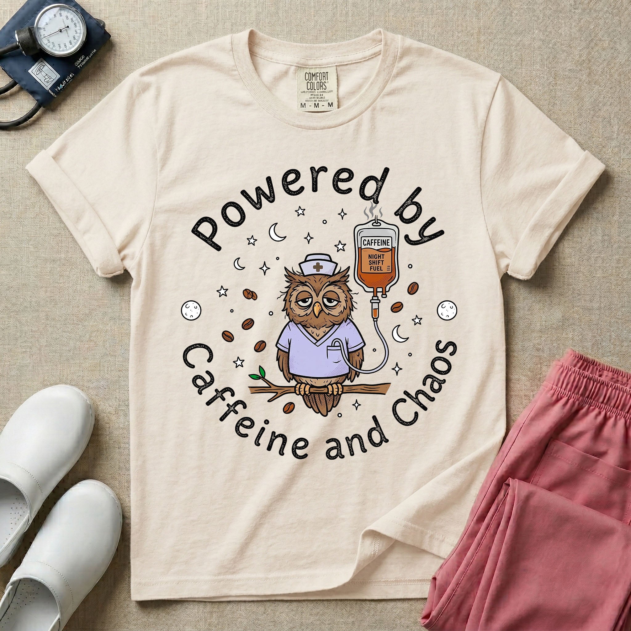 A humorous General Nursing graphic featuring an exhausted owl wearing scrubs and a nurse hat, hooked up to an IV bag labeled CAFFEINE NIGHT SHIFT FUEL, surrounded by coffee beans, stars, and moons, with circular text reading Powered by Caffeine and Chaos.