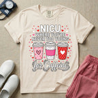 A Valentine's Day themed graphic for a Neonatal Intensive Care Unit featuring the text 'NICU WHERE YOU'RE NEVER TOO YOUNG' stacked above three to-go coffee cups decorated with heart patterns, with 'for Caffeine' written in script at the bottom, all surrounded by small red and pink hearts.