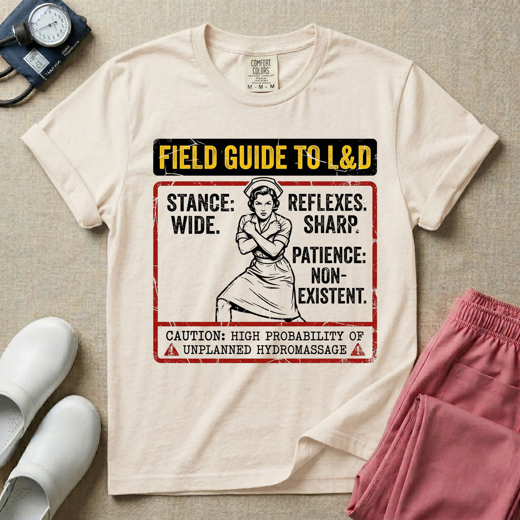 A humorous and retro graphic tee for labor and delivery nurses featuring a vintage nurse illustration alongside the text "FIELD GUIDE TO L&D", "STANCE: WIDE", "REFLEXES: SHARP", "PATIENCE: NON-EXISTENT", and "CAUTION: HIGH PROBABILITY OF UNPLANNED HYDROMASSAGE".