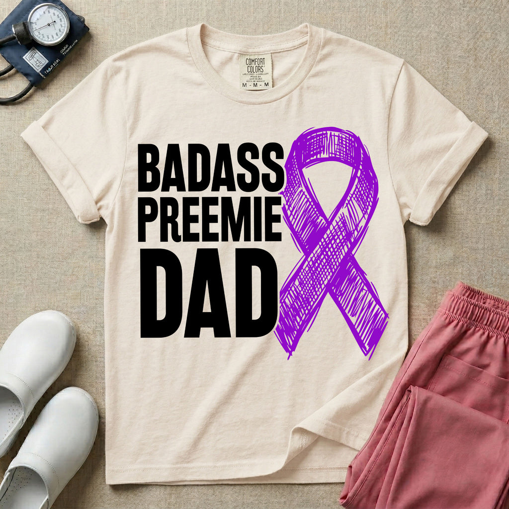 A graphic for the Neonatal Intensive Care Unit featuring the stacked, bold white text 'BADASS PREEMIE DAD' next to a large, textured purple awareness ribbon.