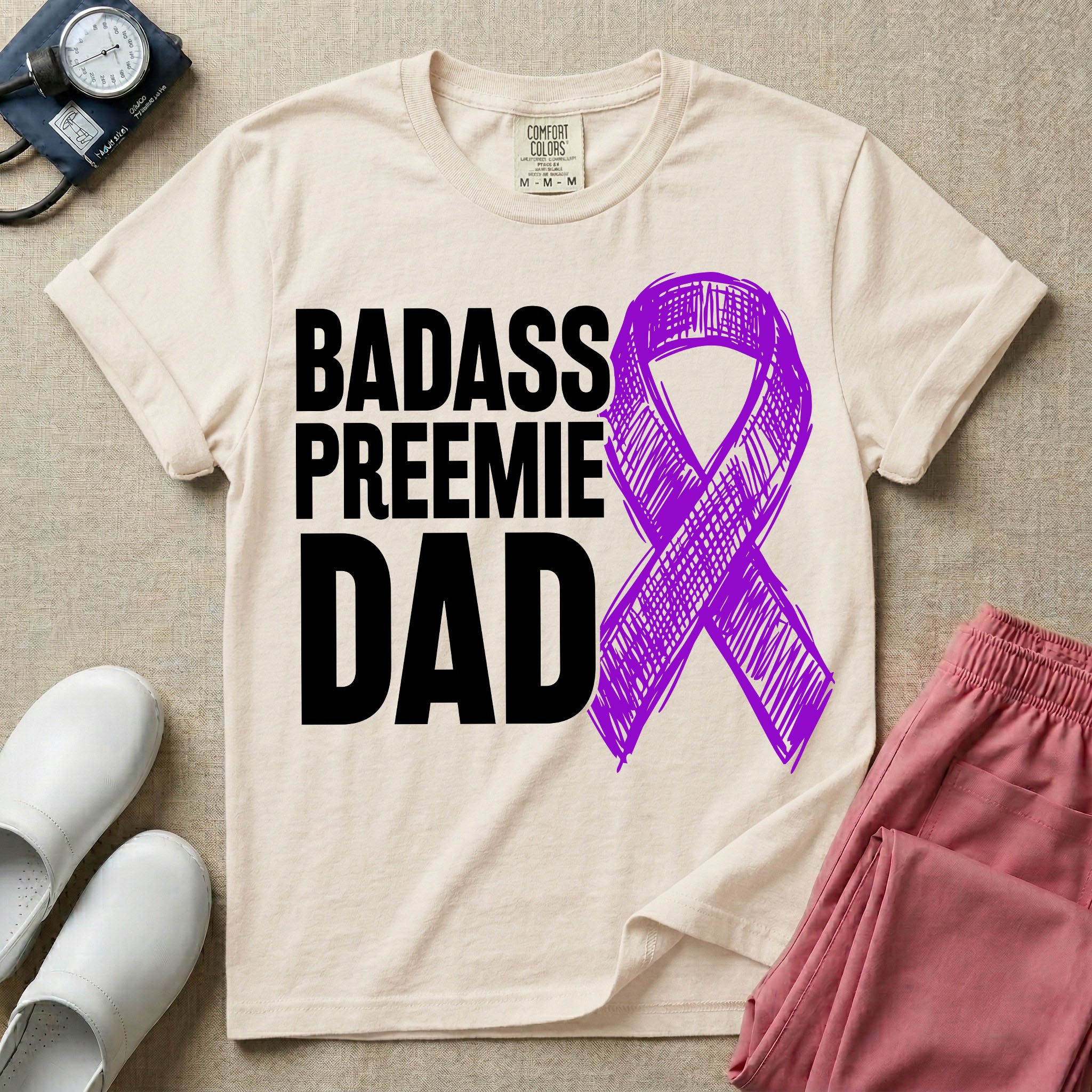 A graphic for the Neonatal Intensive Care Unit featuring the stacked, bold white text 'BADASS PREEMIE DAD' next to a large, textured purple awareness ribbon.