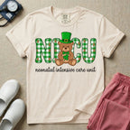 A graphic for a Neonatal Intensive Care Unit featuring the word 'NICU' in green and white plaid patterned letters, with a cute brown teddy bear wearing a leprechaun hat and holding a shamrock sitting in the middle, and the cursive text 'neonatal intensive care unit' underneath.