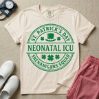 A circular green graphic featuring a leprechaun hat, shamrocks, and the text ST. PATRICK'S DAY SHENANIGANS SQUAD surrounding a center banner that reads NEONATAL ICU.