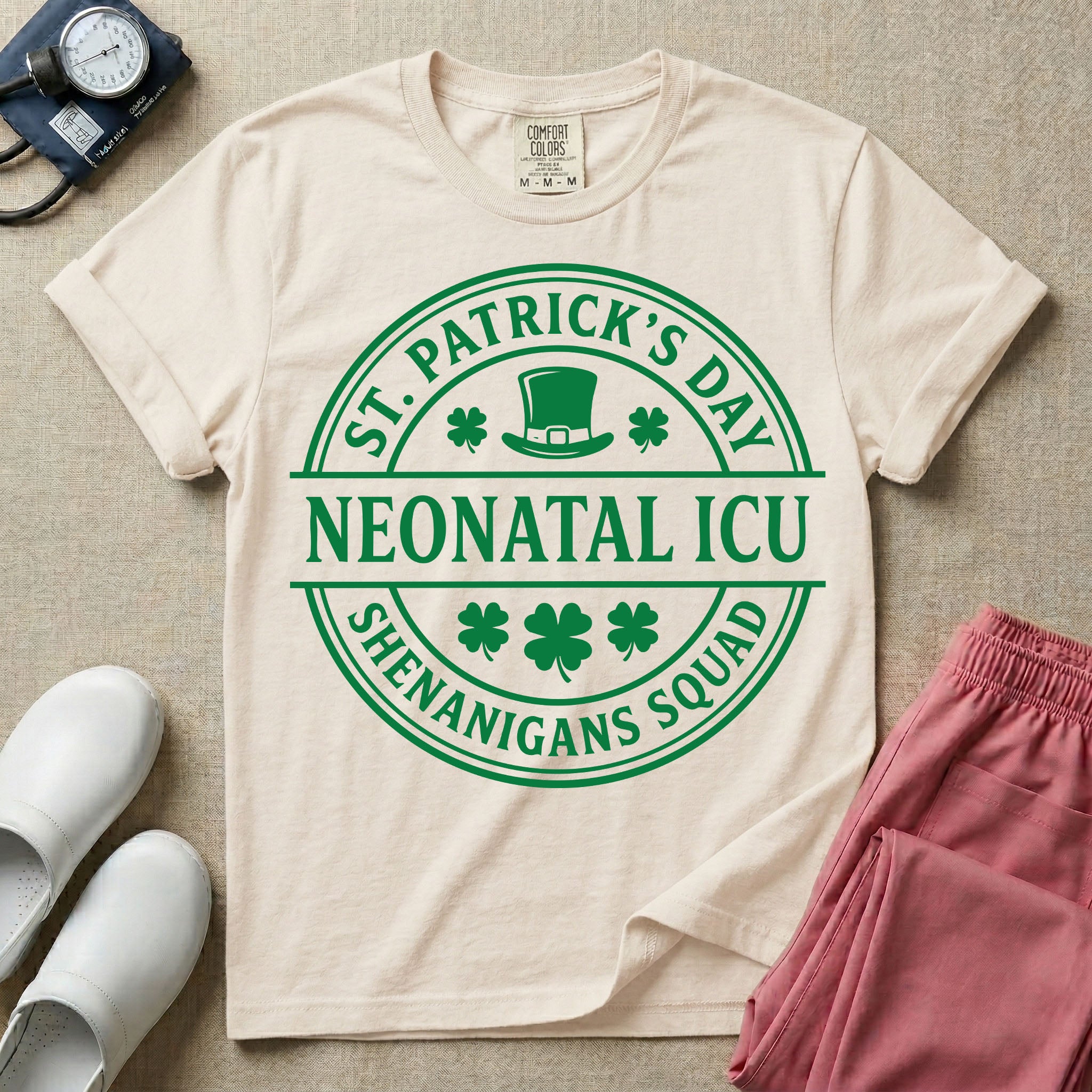 A circular green graphic featuring a leprechaun hat, shamrocks, and the text ST. PATRICK'S DAY SHENANIGANS SQUAD surrounding a center banner that reads NEONATAL ICU.