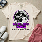A humorous Labor and Delivery nurse graphic featuring a screaming face morphing out of a full moon, accompanied by purple dripping text that reads L&D: FULL MOON MADNESS and distressed black text below reading NO SLEEP. NO BREAKS. NO MERCY.