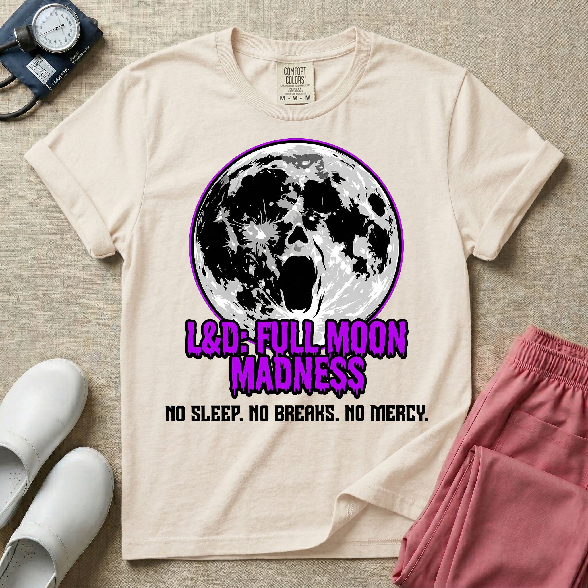 A humorous Labor and Delivery nurse graphic featuring a screaming face morphing out of a full moon, accompanied by purple dripping text that reads L&D: FULL MOON MADNESS and distressed black text below reading NO SLEEP. NO BREAKS. NO MERCY.