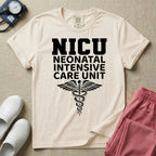 A t-shirt featuring the word NICU in large collegiate block letters above the spelled-out text Neonatal Intensive Care Unit and a medical caduceus symbol.