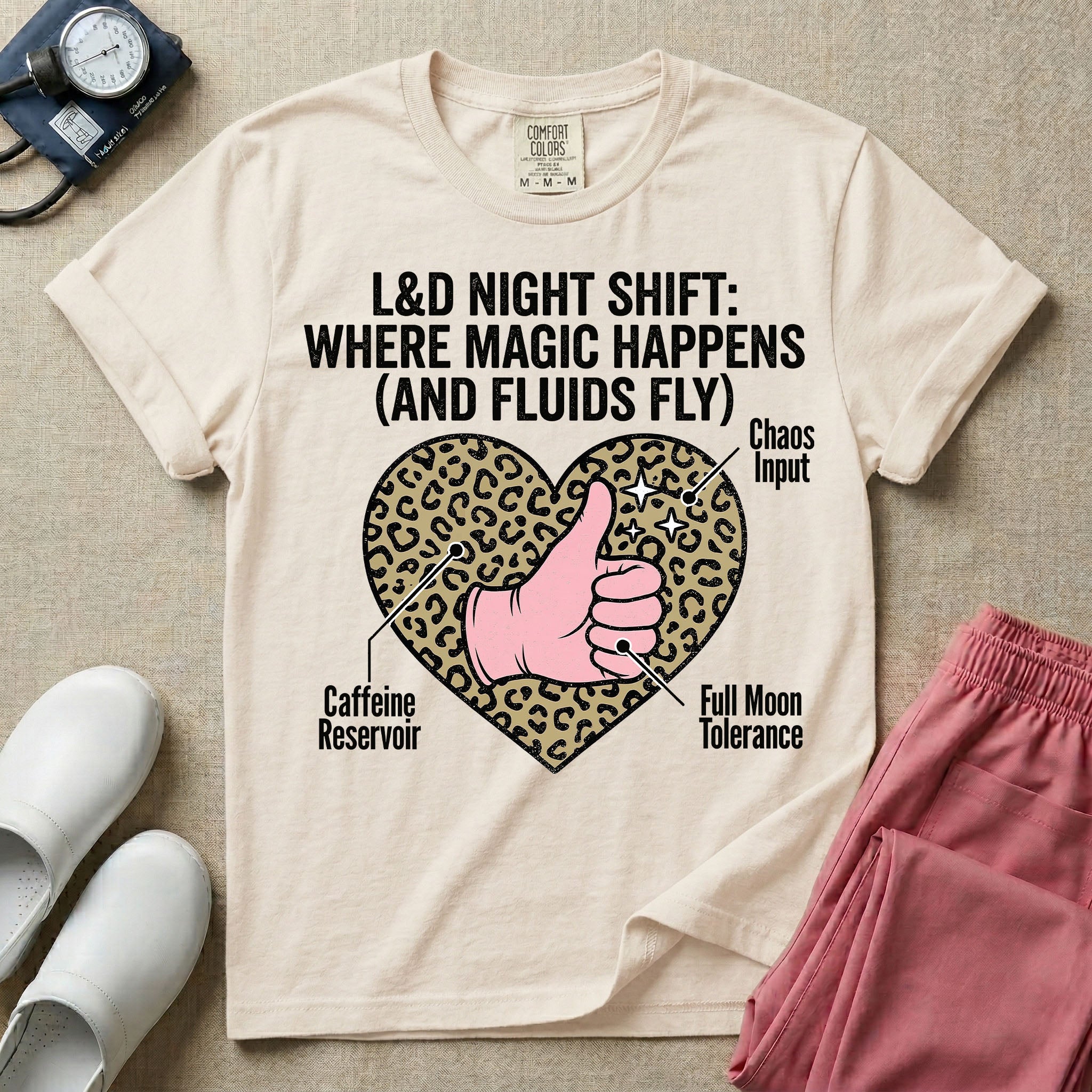Labor and Delivery L&D nursing t-shirt featuring a leopard print heart diagram with a gloved thumbs-up and the text "L&D NIGHT SHIFT: WHERE MAGIC HAPPENS (AND FLUIDS FLY)"