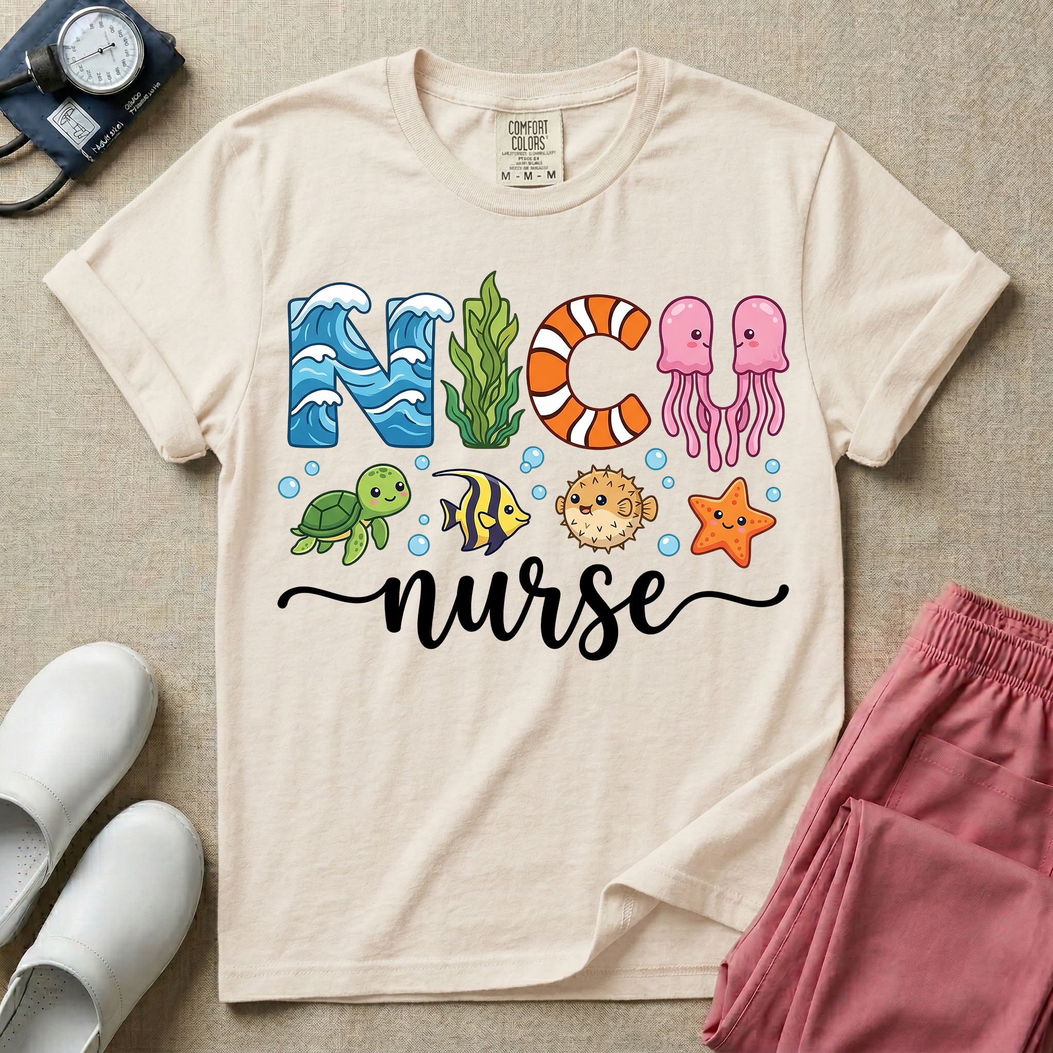 A cute t-shirt for NICU nurses featuring the text "NICU nurse" where the letters are designed with ocean elements like waves, seaweed, and a jellyfish, surrounded by under the sea creatures including a sea turtle, tropical fish, pufferfish, and starfish.