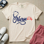 General nursing t-shirt with a minimalist cursive Nurse text integrated with a navy blue stethoscope and a red heartbeat graphic.