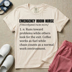 A minimalist t-shirt for emergency room nurses featuring a dictionary definition graphic for the term "EMERGENCY ROOM NURSE" with a phonetic pronunciation and a humorous description about running toward problems, using coffee as fuel, and thriving in chaos.