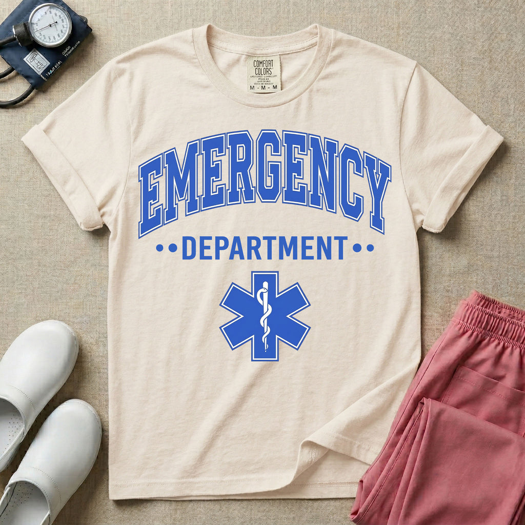A classic varsity-style t-shirt for emergency room nurses featuring the word "EMERGENCY" in a large, arched blue collegiate font above the word "DEPARTMENT", centered over a blue Star of Life medical symbol.