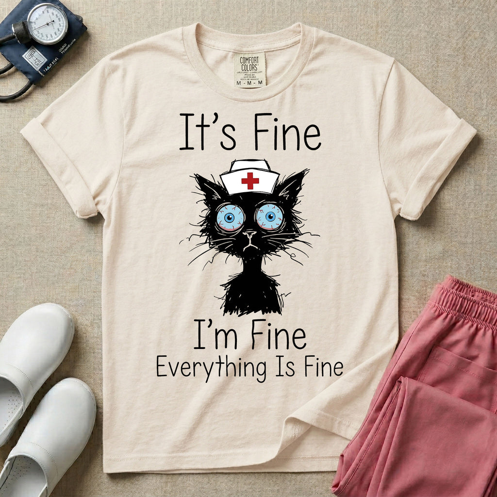 General nursing t-shirt featuring a humorous graphic of a frazzled black cat wearing a medical cross nurse cap alongside the text "It's Fine I'm Fine Everything Is Fine".