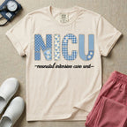 A t-shirt for NICU nurses featuring the large text "NICU" designed to look like faux embroidery with floral and plaid patterns, and the words "neonatal intensive care unit" written in a delicate script font underneath.