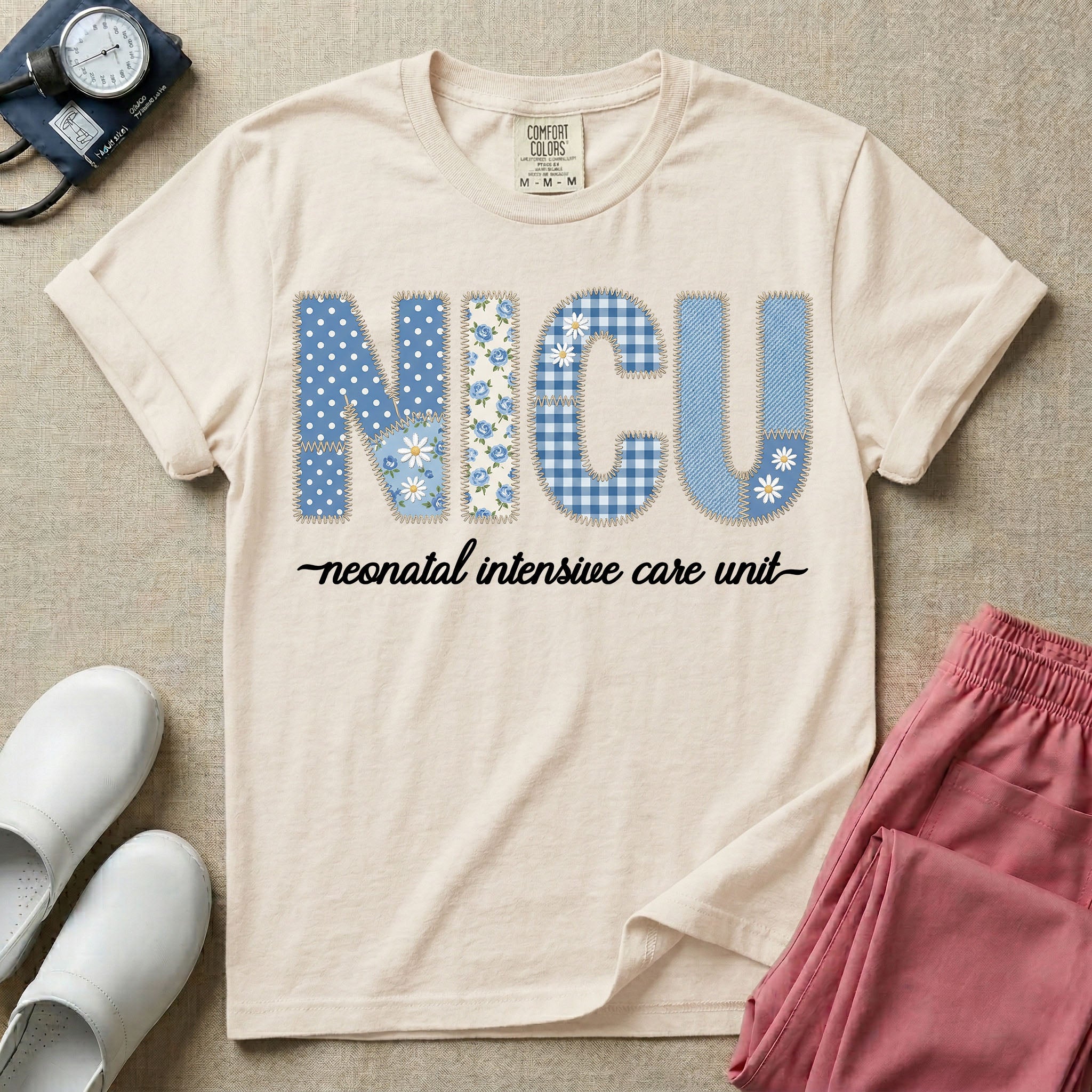 A t-shirt for NICU nurses featuring the large text "NICU" designed to look like faux embroidery with floral and plaid patterns, and the words "neonatal intensive care unit" written in a delicate script font underneath.