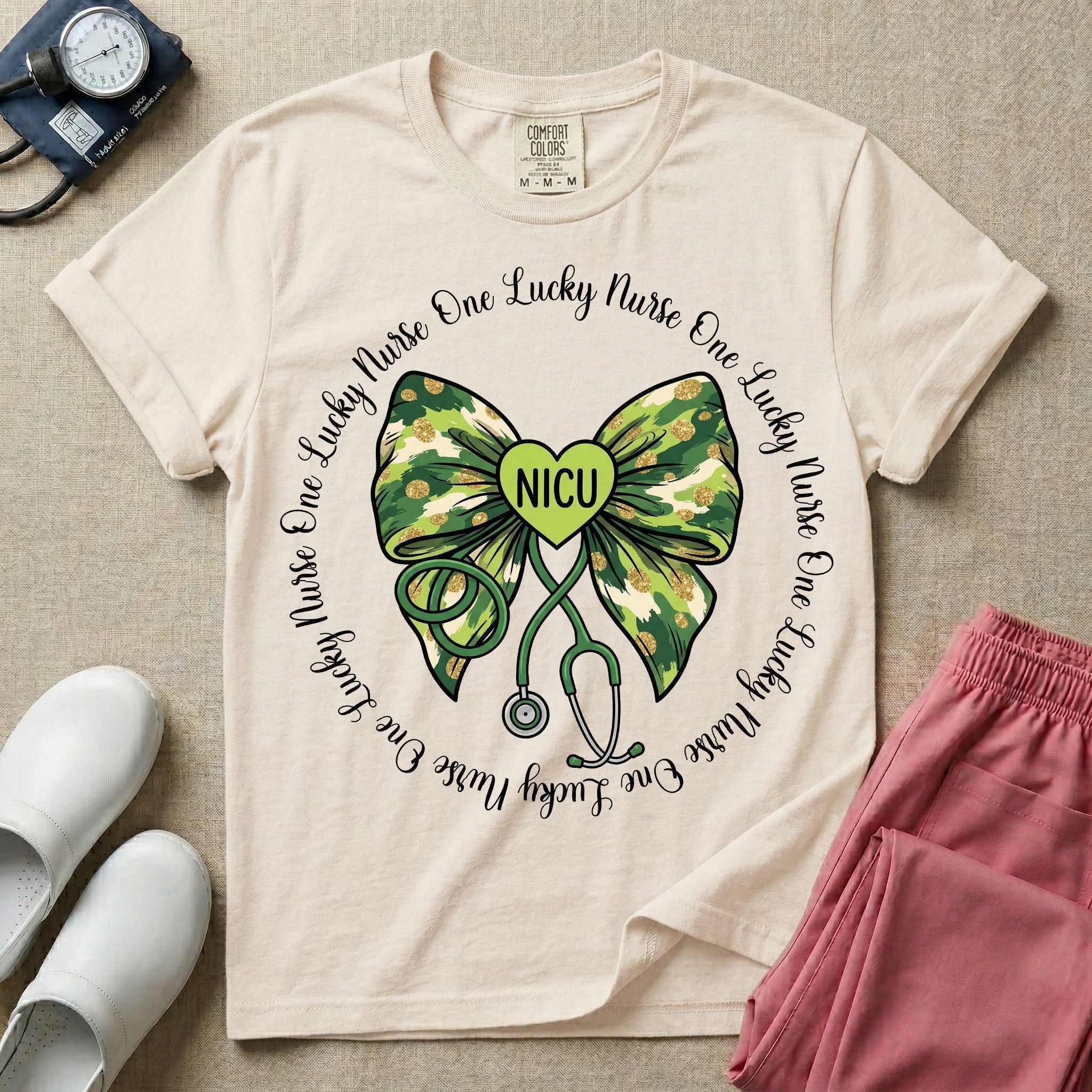A graphic for a Neonatal Intensive Care Unit featuring a green camouflage bow with a stethoscope dangling from the bottom, a green heart in the center reading 'NICU', and the phrase 'One Lucky Nurse' repeating in a circle around the design.