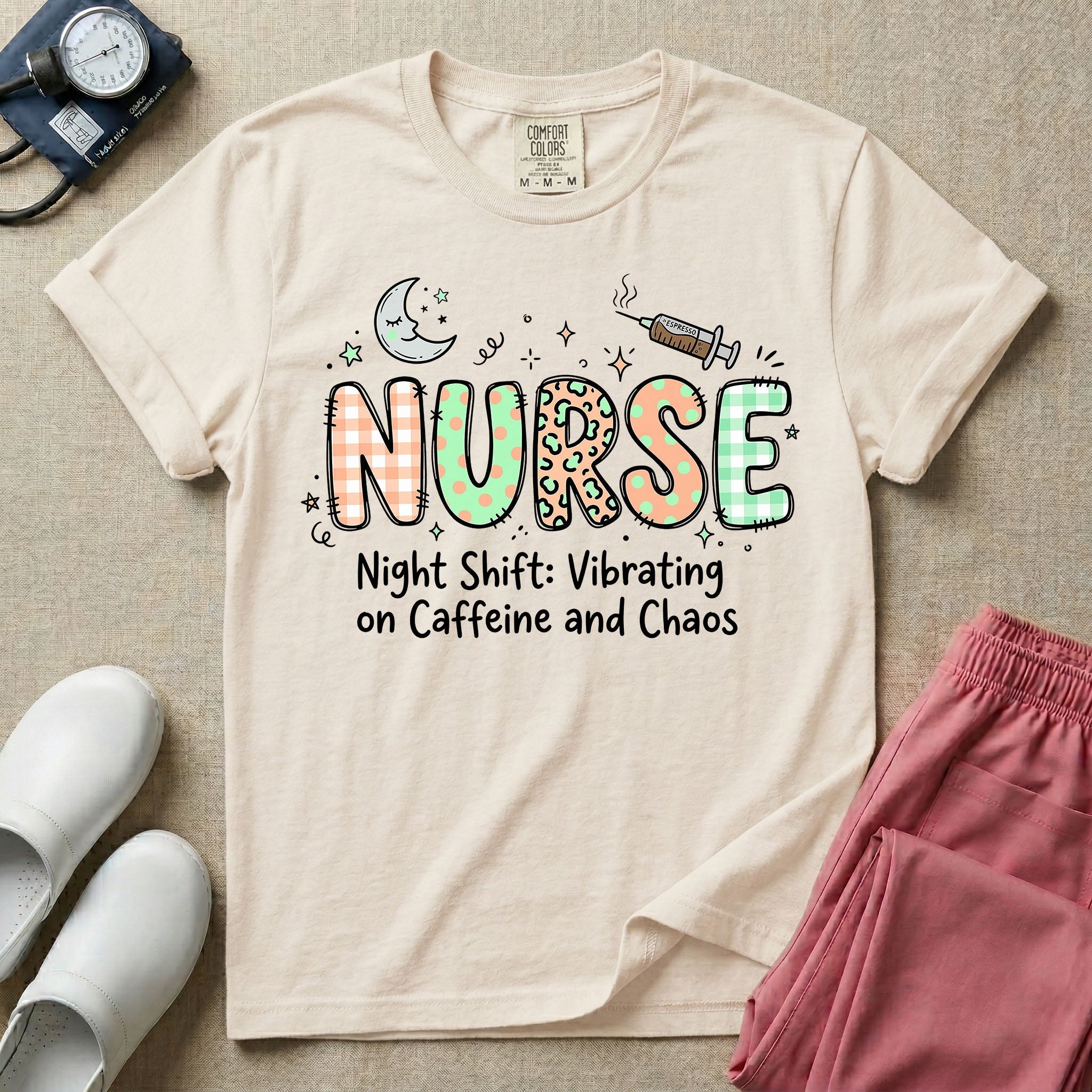A humorous General Nursing graphic featuring the word NURSE in large, playfully patterned letters including plaid, leopard print, and floral designs, accented by a sleeping crescent moon and a syringe, positioned above text that reads Night Shift: Vibrating on Caffeine and Chaos.