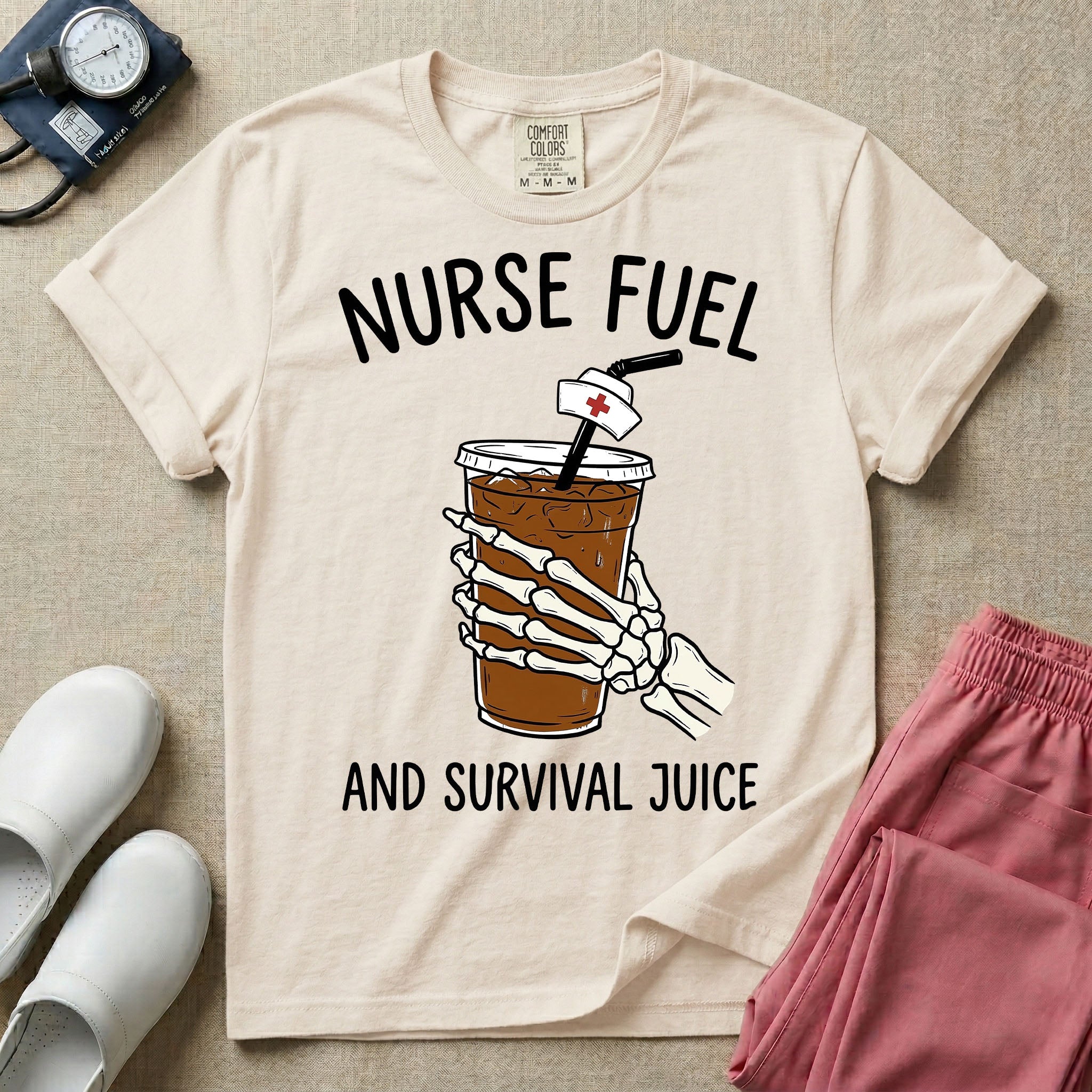 General nursing t-shirt featuring a graphic of a skeleton hand holding an iced coffee cup with a nurse cap on the straw and the text "NURSE FUEL AND SURVIVAL JUICE"