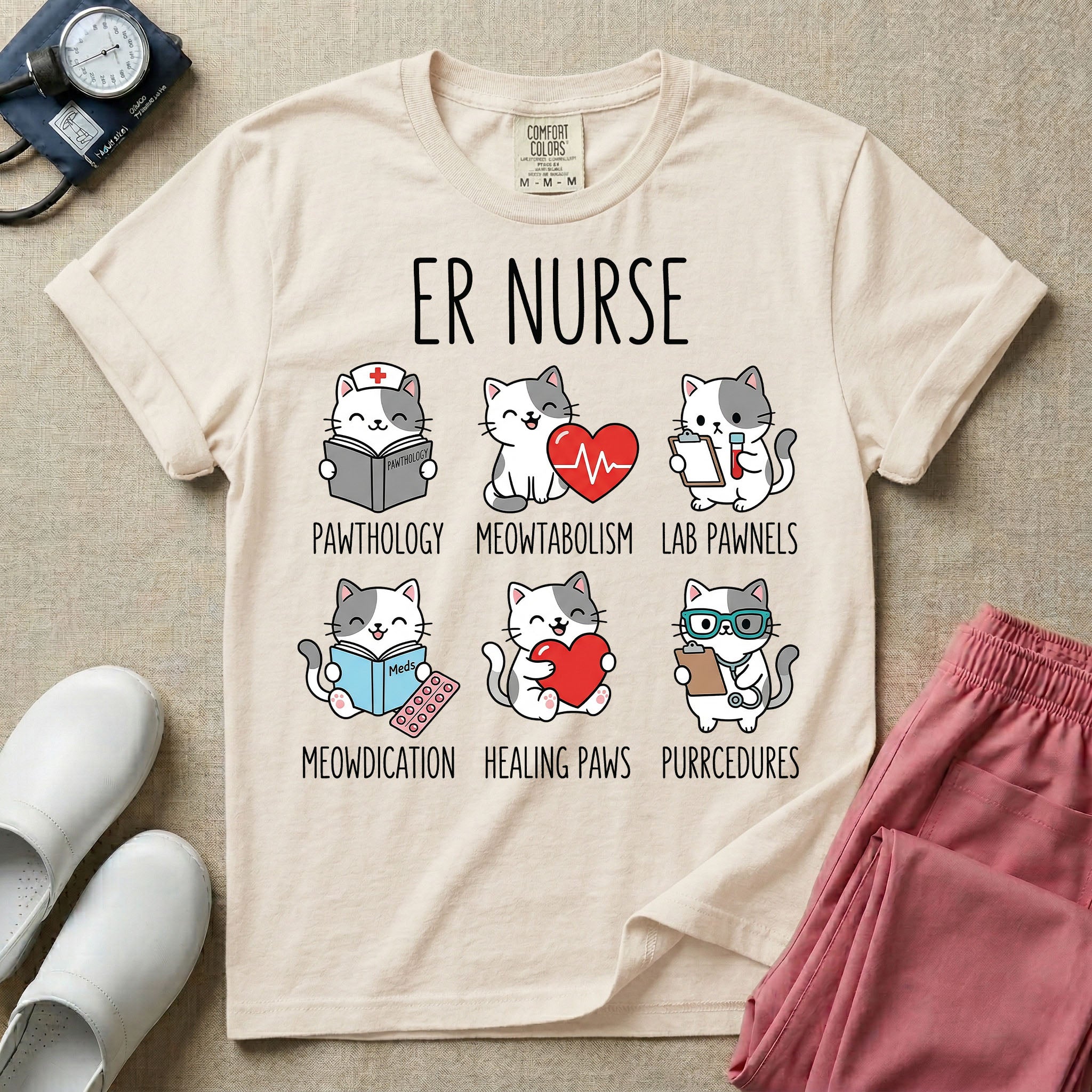 A funny t-shirt for emergency room nurses featuring the text "ER NURSE" above a grid of six cute cartoon cats demonstrating medical puns, including a cat reading for "PAWTHOLOGY", a cat with an ECG heart for "MEOWTABOLISM", a cat holding a test tube for "LAB PAWNELS", a cat with pills for "MEOWDICATION", a cat holding a heart for "HEALING PAWS", and a cat with a stethoscope for "PURRCEDURES".