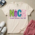 A t-shirt featuring the acronym NICU creatively spelled out using a green letter N, a purple baby bottle, a teal letter C, and a pink outlined teddy bear, with the words Neonatal Intensive Care Unit written in cursive script below.
